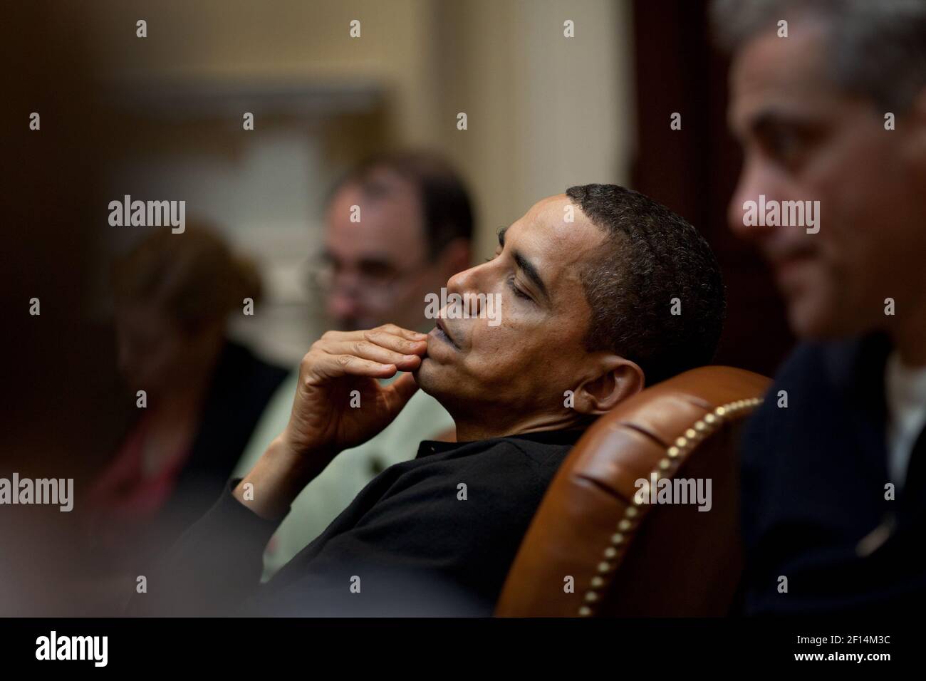 President Obama reflects during an economic meeting with advisors in the Roosevelt Room. He is seated between Senior Advisor David Axelrod and Chief of Staff Rahm Emanuel  right. 3/15/09. Stock Photo