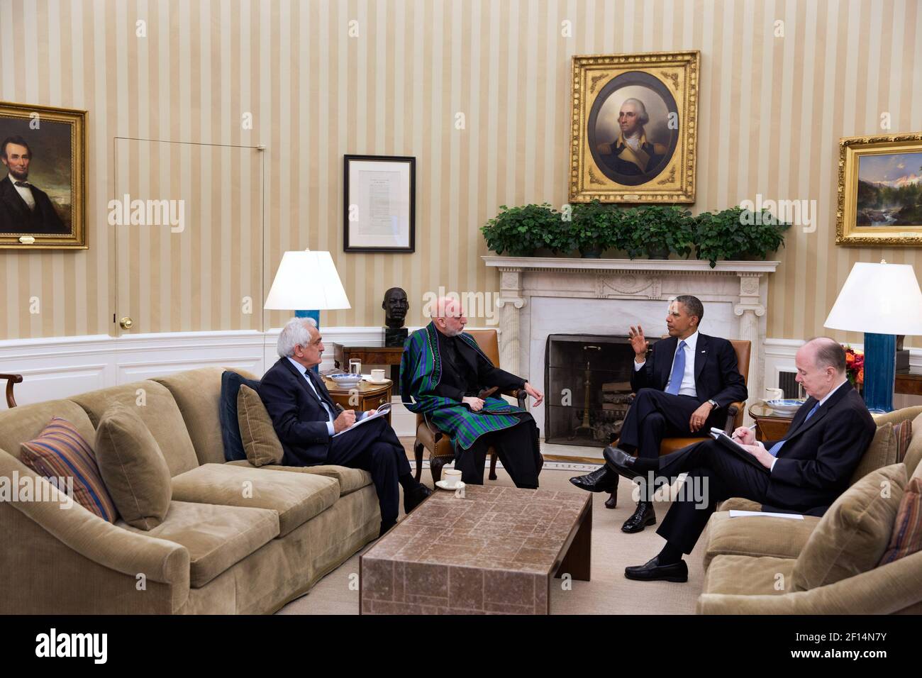 President Barack Obama and President Hamid Karzai of Afghanistan participate in a bilateral meeting in the Oval Office, Jan. 11, 2013.  Dr. Rangin Dadfar Spanta, Afghan National Security Advisor, left, and National Security Advisor Tom Donilon, attend Stock Photo