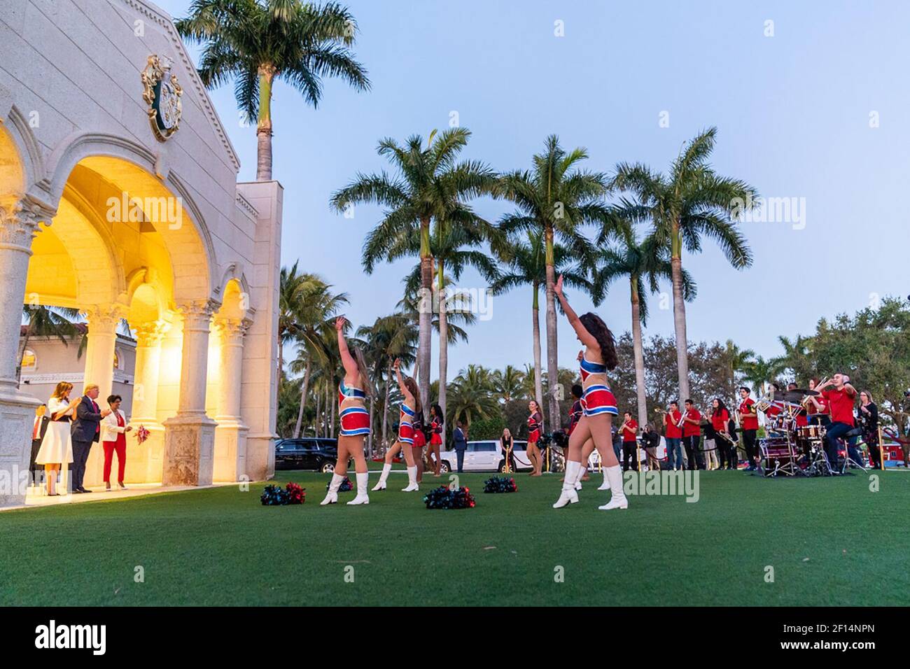 President Donald Trump and First Lady Melania Trump listen to the members of the Florida Atlantic University marching band Sunday evening Feb. 2 2020 outside the Trump International Golf Club in West Palm Beach Fla. prior to attending a Super Bowl party. Stock Photo