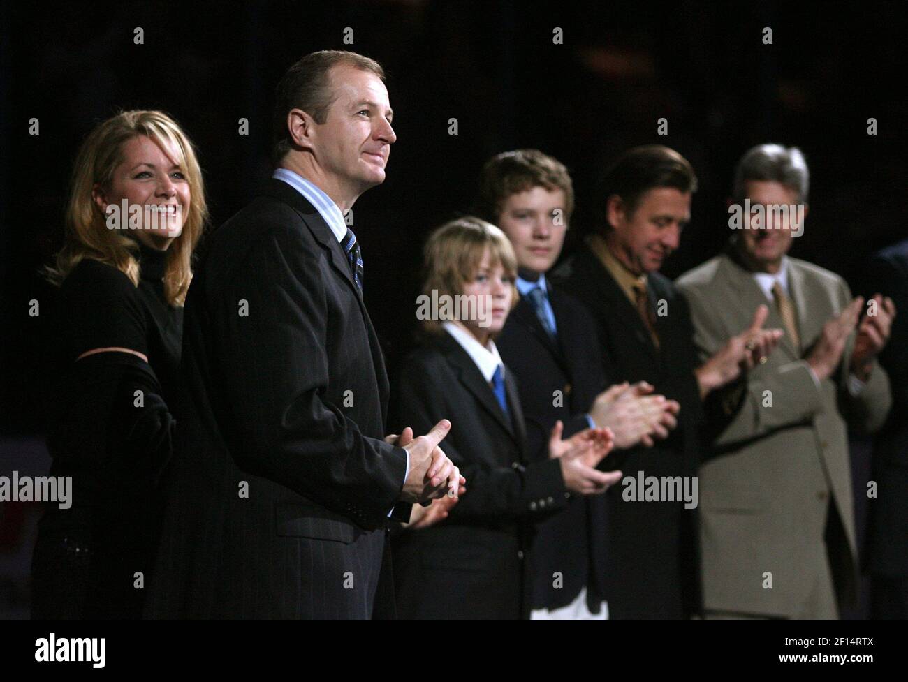 The family of former St. Louis Blues player Igor Korolev hold his jersey  during a tribute ceremony before the St. Louis Blues-Chicago Blackhawks  hockey game at the Scottrade Center in St. Louis