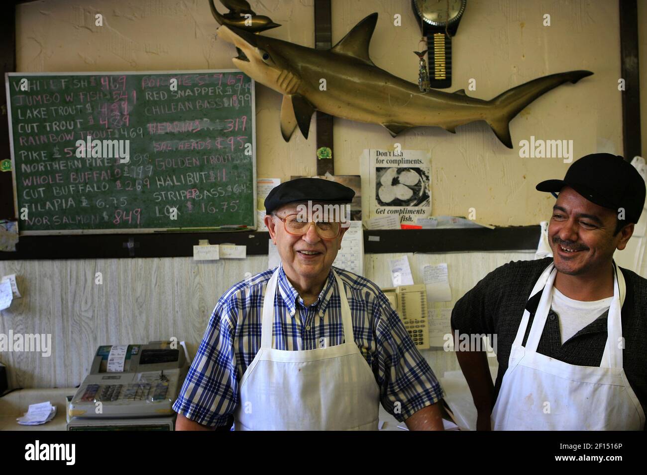 Robert's Fish Market owner and Mexican immigrant Arturo Venegas, right