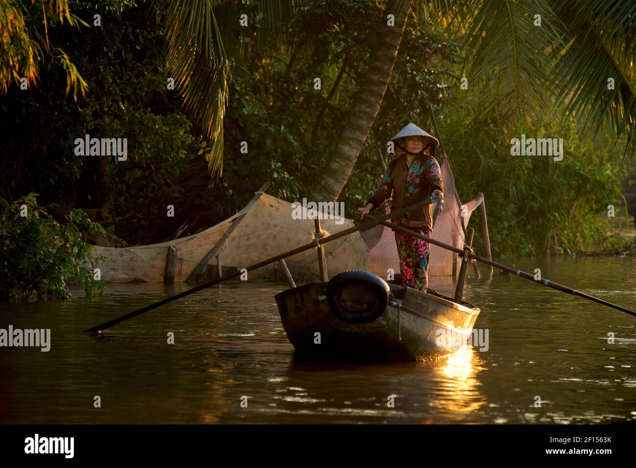 Vietnamese woman on her boat at Phong Điền early morning floating market. Near Can Tho, Mekong Delta, Vietnam Stock Photo