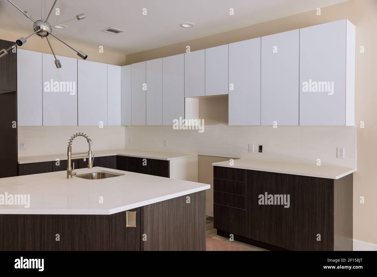Installing new sink tap in modern kitchen Stock Photo Alamy
