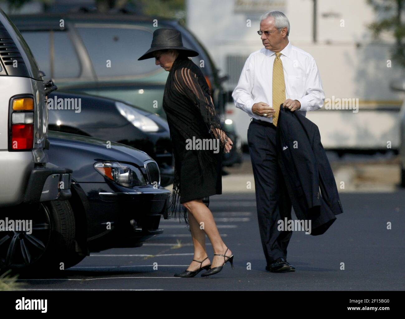 North Carolina head basketball coach Roy Williams and his wife, Wanda,  left, arrive at Holy Family Catholic Church in Clemmons, North Carolina,  for the burial service of Wake Forest basketball coach Skip