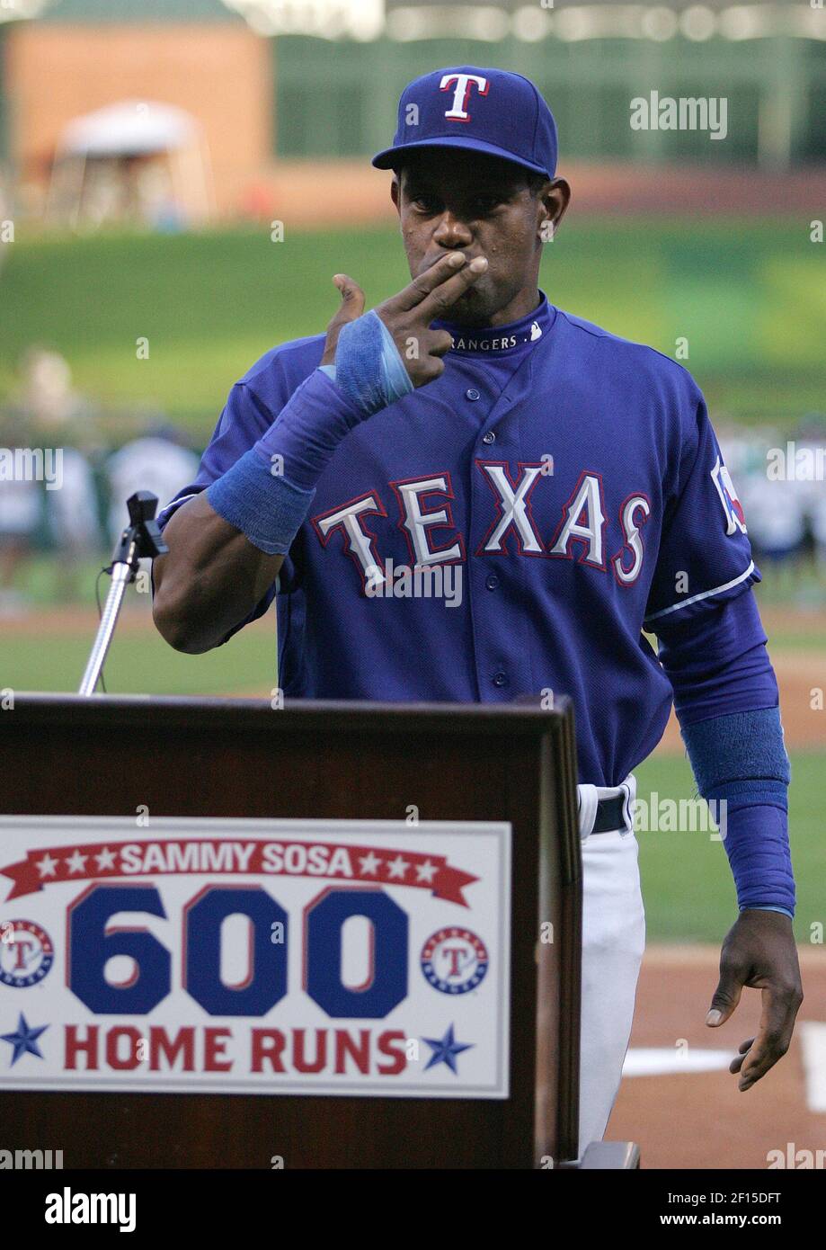 The Texas Rangers' Sammy Sosa gestures during a ceremony to honor him in  for his 600th home run prior to the game against the Cleveland Indians at  Rangers Ballpark in Arlington, Texas