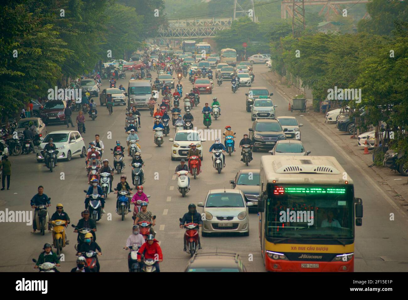 Urban traffic, Hanoi, Vietnam. Busy street with motorcycles, cars and buses. Stock Photo