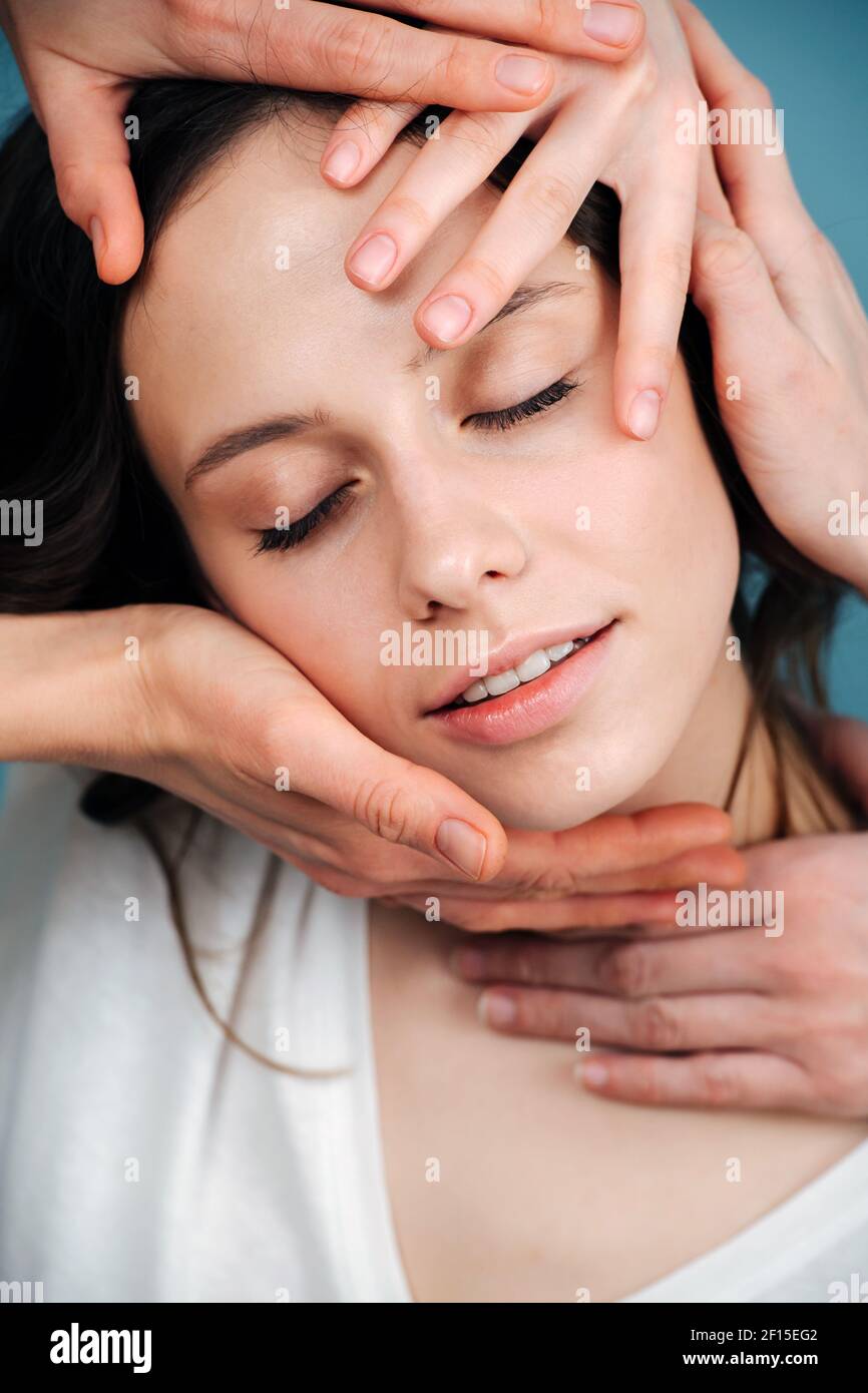 Blissed Out Woman Having Pleasurable Face Massage from Multiple