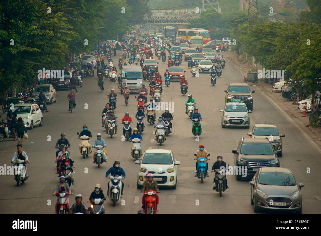 Urban traffic, Hanoi, Vietnam. Busy street with motorcycles, cars and buses. Stock Photo