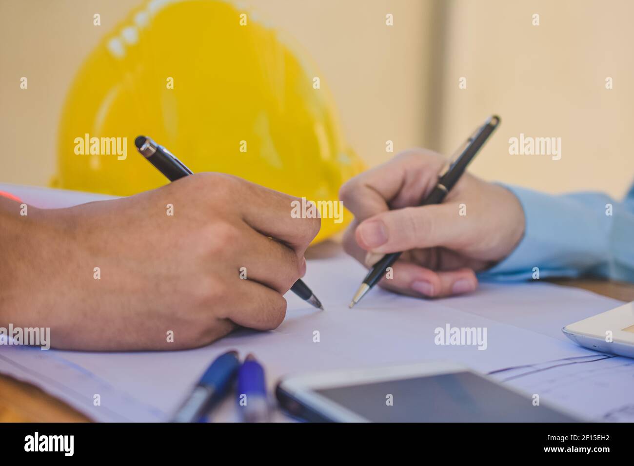 Close up hand check design on blueprint for building construction project Stock Photo