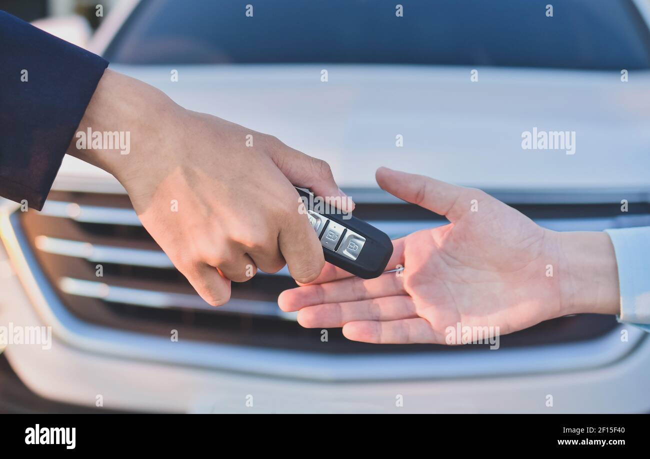 Hand giving key car business sale rent insurance Stock Photo - Alamy