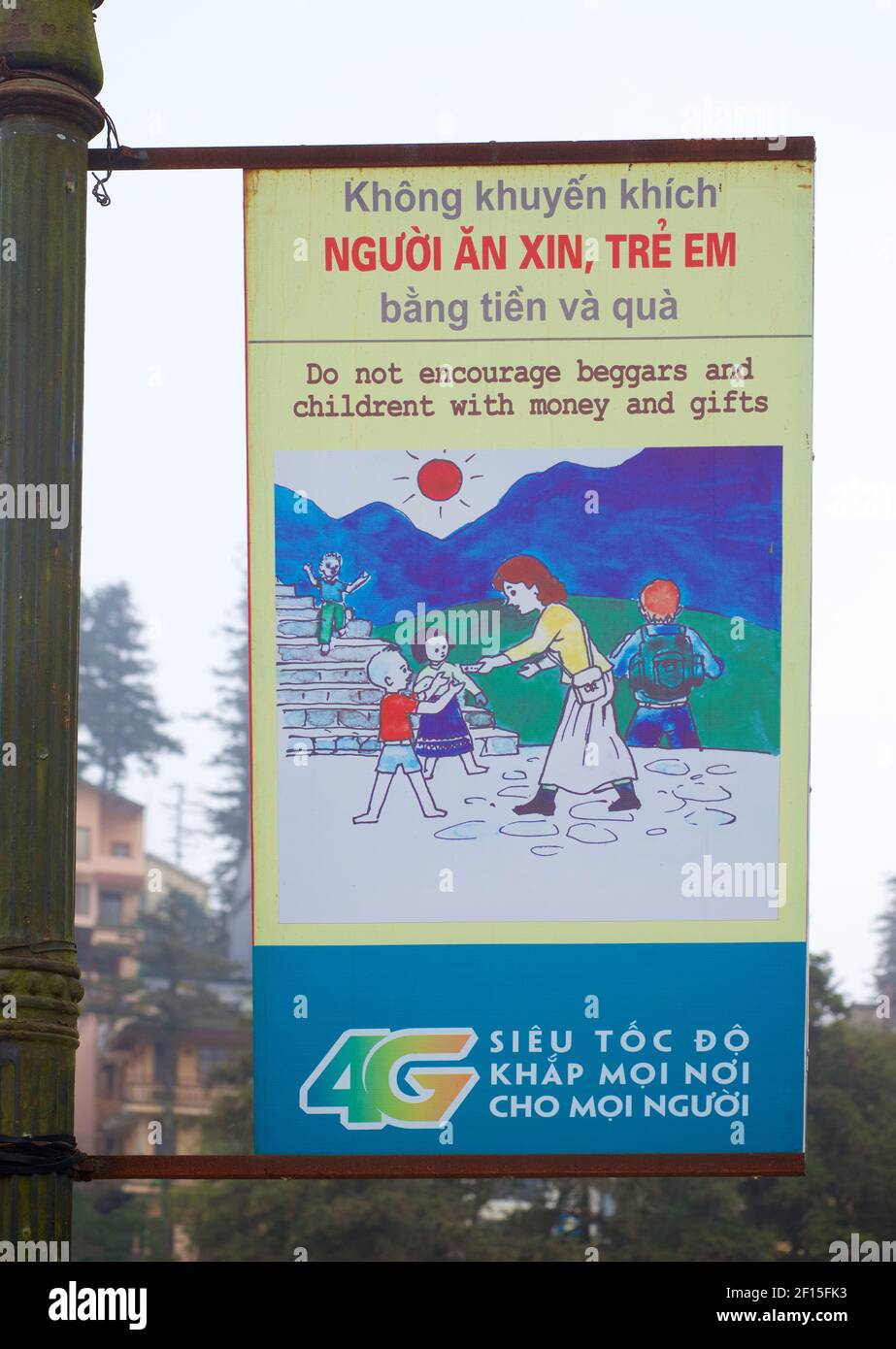 Local advisory sign for tourists to Sapa, Vietnam: DO NOT ENCOURAGE BEGGARS AND CHILDREN WITH MONEY AND GIFTS. Stock Photo