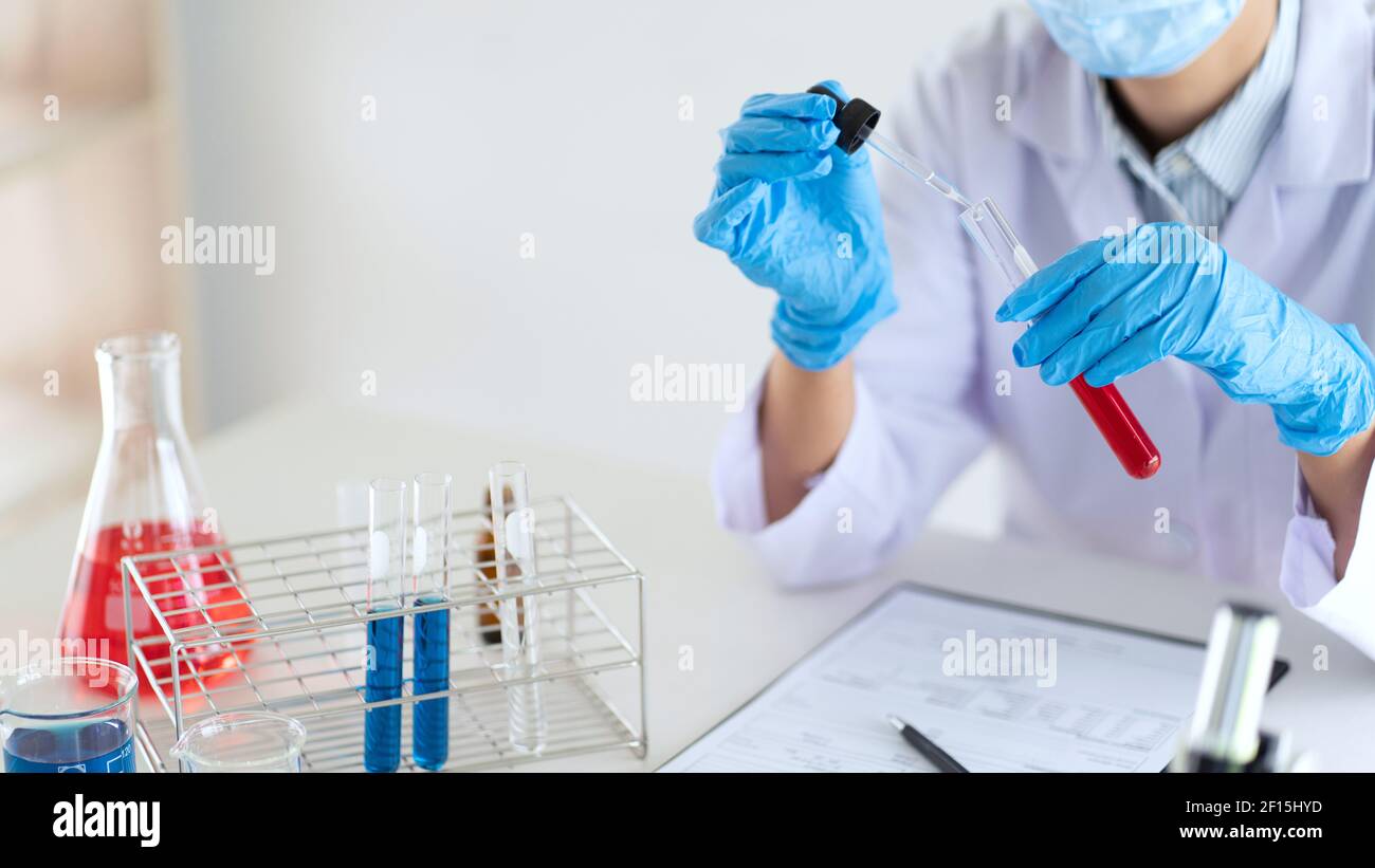 Young Asian scientist Working looking through a microscope doing ...