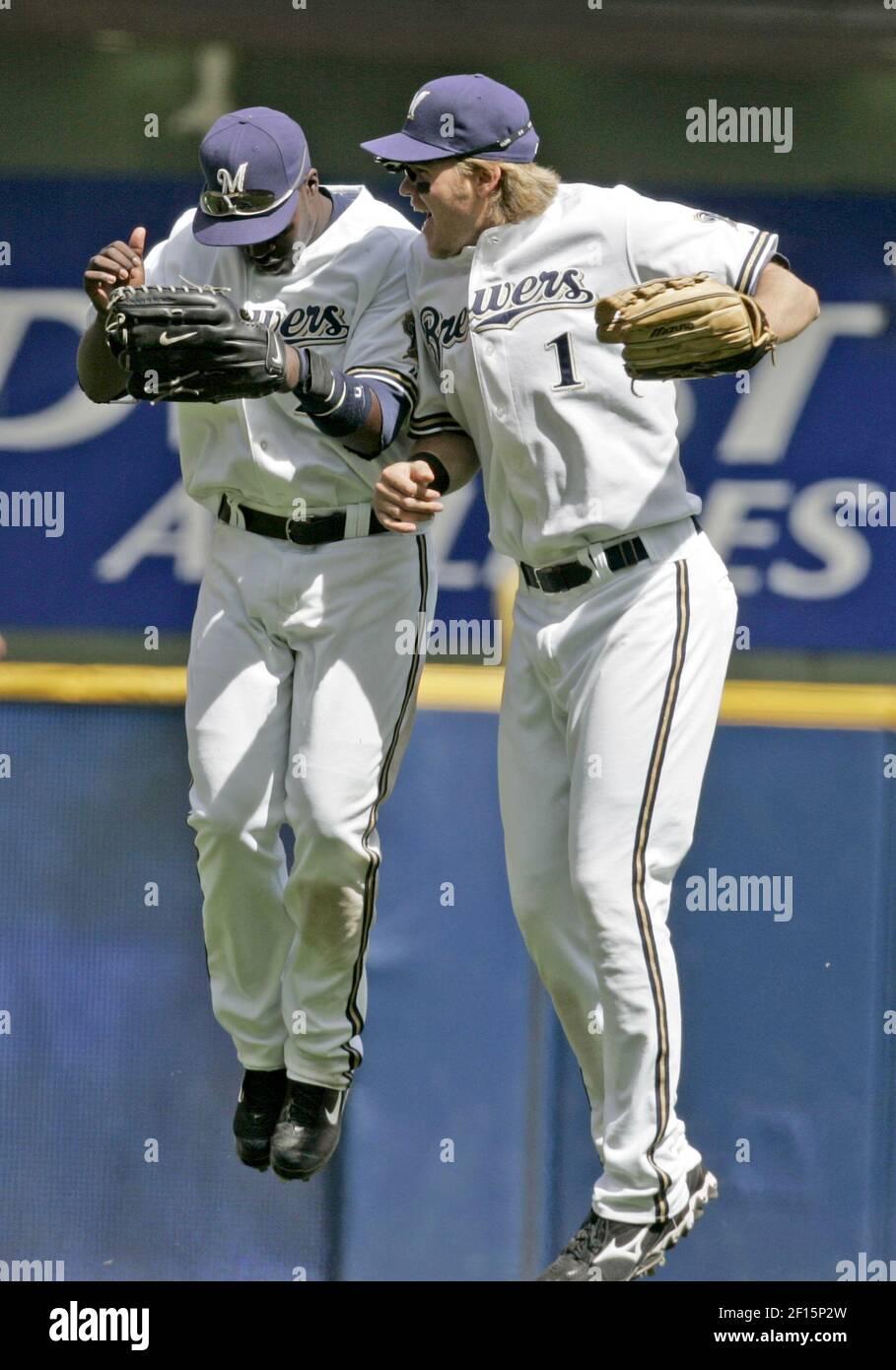 Milwaukee Brewers' Corey Hart, and Bill Hall leap in celebration for
