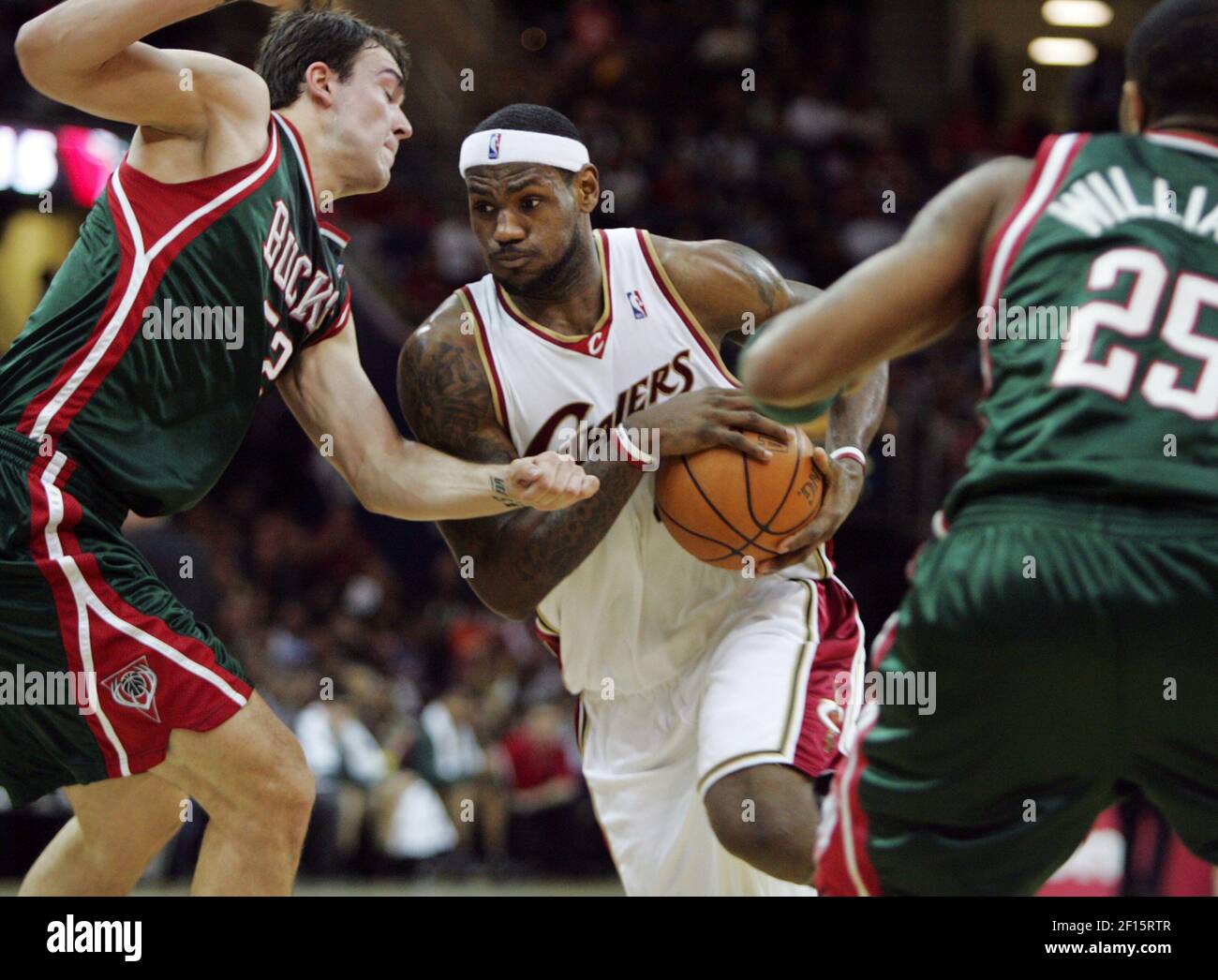 Cleveland Cavaliers' LeBron James (center) drives in between Milwaukee ...