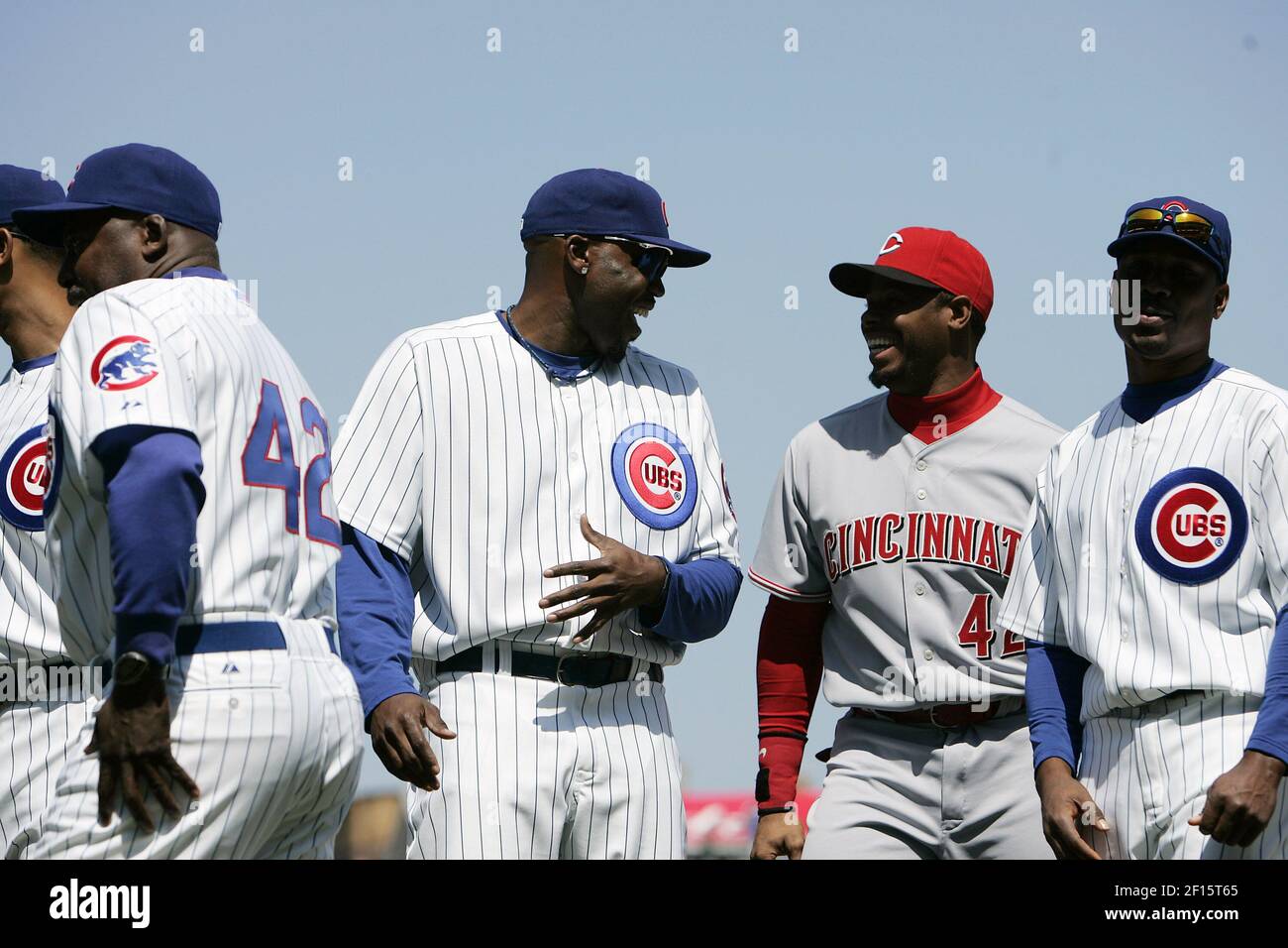 Chicago Cubs Cliff Floyd (center, left) laughs it up with Cincinnati Reds  Ken Griffey, Jr., and Jacque Jones (right) as they line up with other Cubs  players and coaches to honor Jackie