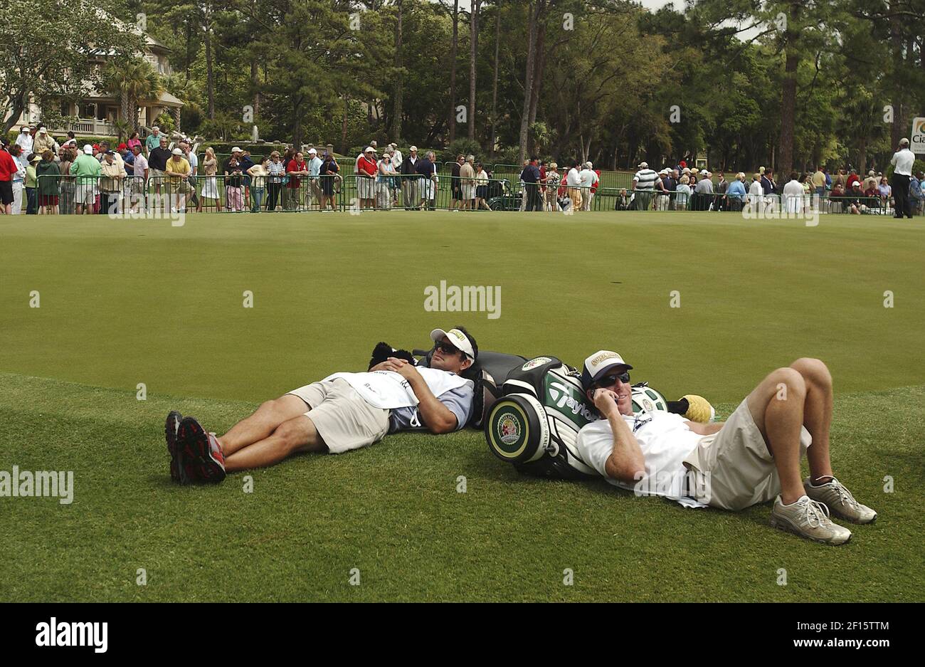 Mark Miller, left, caddie for Jeff Maggert, and Mike Bestor, caddie for