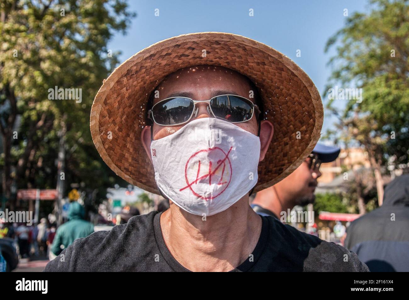 A protester wearing a face mask with a protest message during the demonstration. A group of pro-democracy protesters, on an almost 250 kilometer walk arrived in Bangkok on 7 March. The group was led by Jatupat Boonpattararaksa also known as 'Pai Daodin' or 'Pai' a pro-democracy activist who has been walking for 20 days starting from the Thao Suranaree statue in Nakhon Rachasima province on 16 February 2021 to The Democracy Monument in Bangkok on 7 March 2021 to protest the imprisonment of 4 pro-democracy activists (Somyot Pruksakasemsuk, Patiwat Saraiyam, Parit 'Penguin' Chivarak and Anon Namp Stock Photo