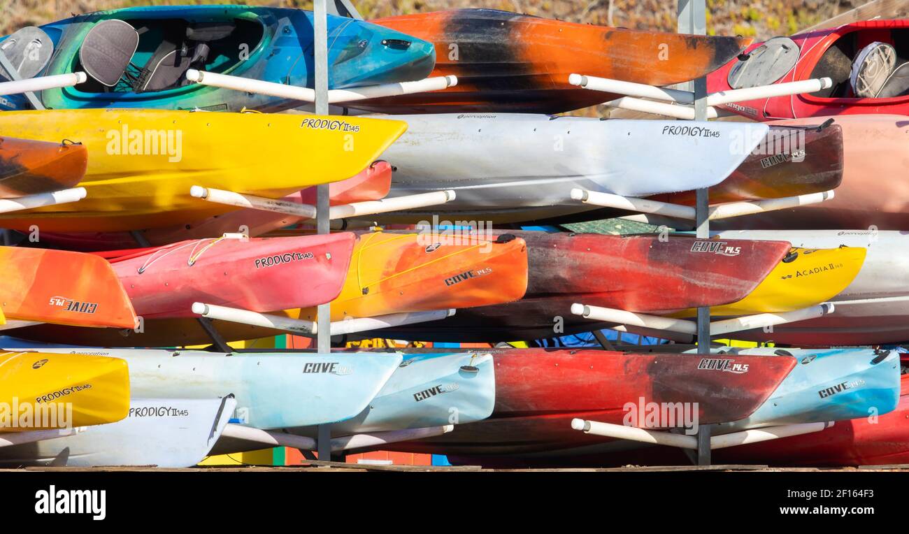 Multicolored Kayaks Stacked Stock Photo