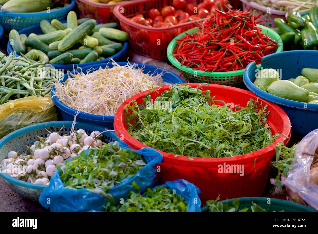 Vegetables in colouful baskets for sale at market,Bac Ha. Lao Cai Province, Vietnam Stock Photo