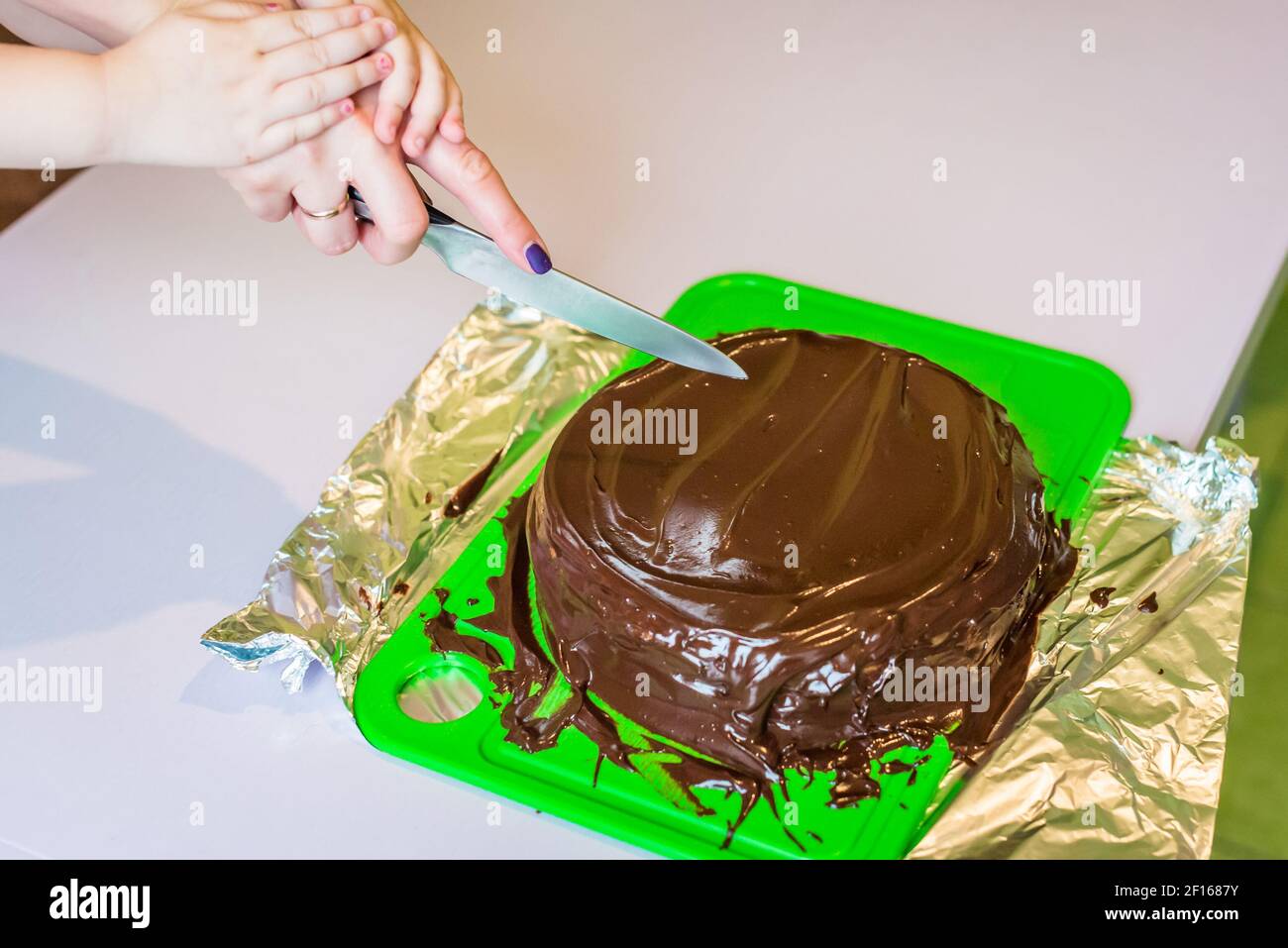 Baby hands cut the cake Stock Photo