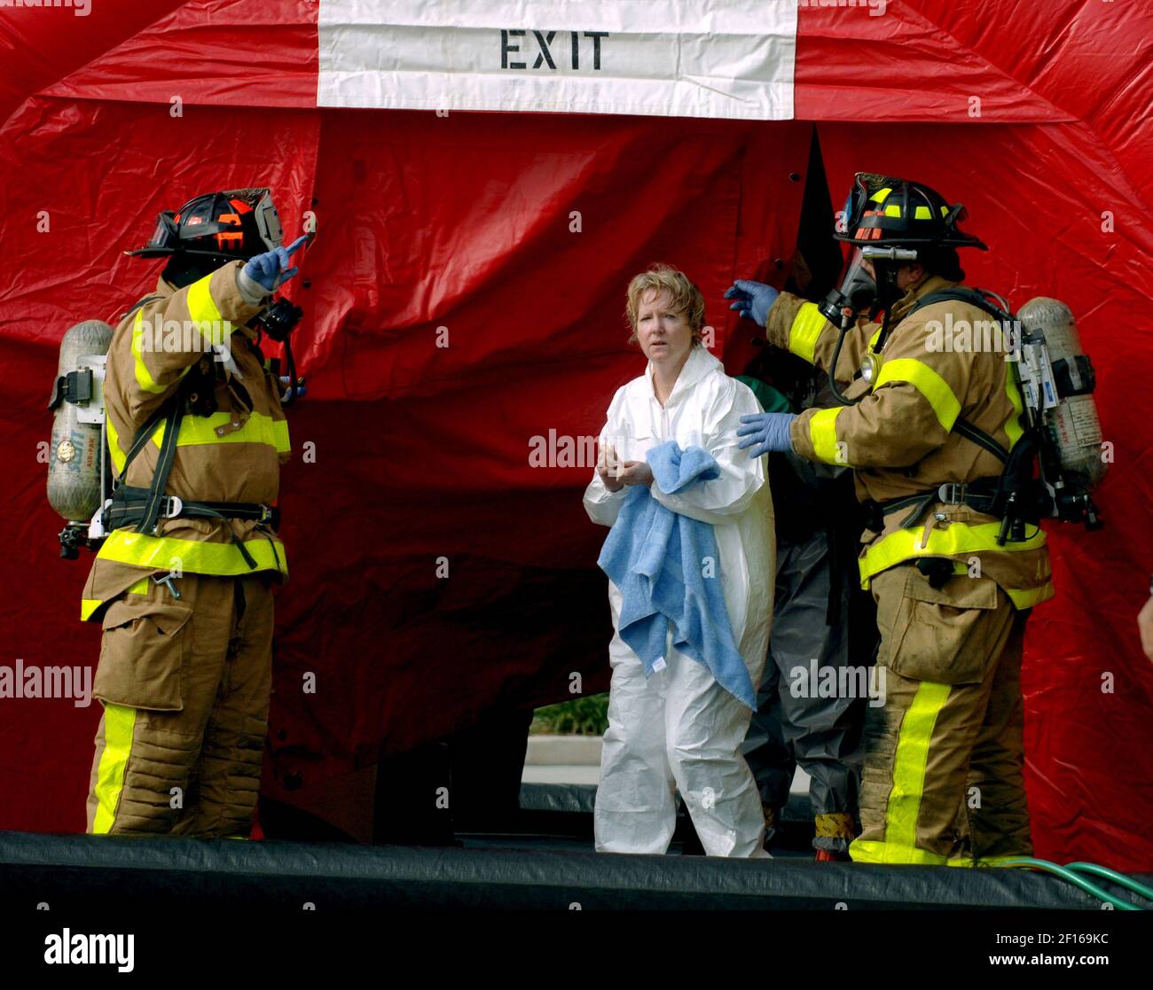 Tom Sheppard, left, and Atie Makhoul of Palm Beach County Fire Rescue,  escort a woman from a decontamination tent following the evacuation of the Palm  Beach County Courthouse in West Palm Beach,