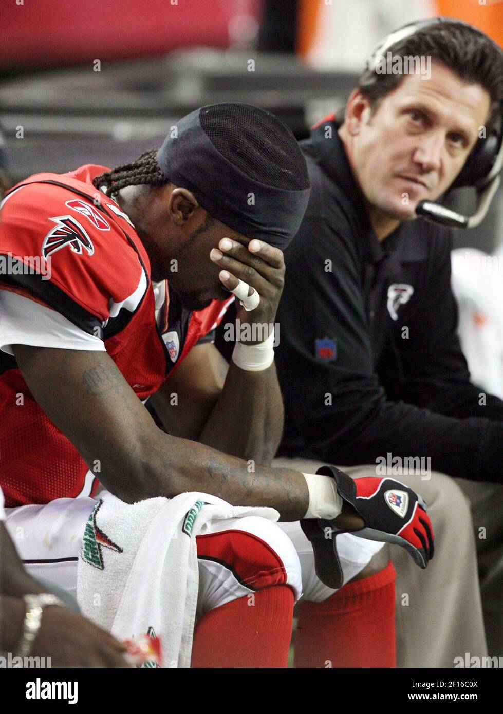 Michael Vick of the Atlanta Falcons sits on the bench in the