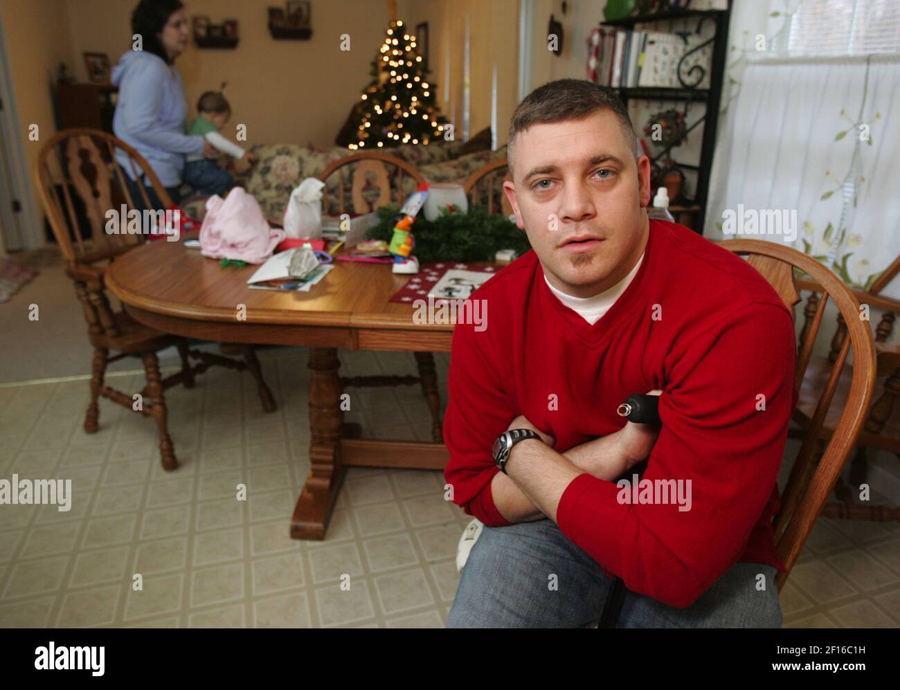 Retired U.S. Air Force Sgt. David Lyles holds his cane as he sits at ...