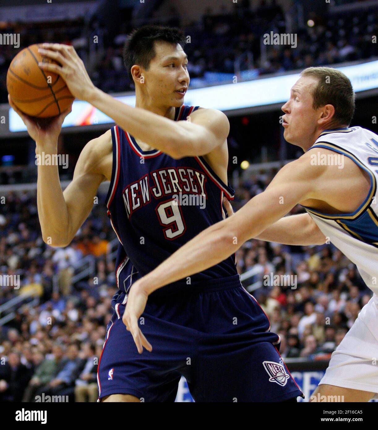 New Jersey Nets' Yi Jianlian, of China, left, blocks a shot by Boston  Celtics' Kendrick Perkins (43) during the first half of an NBA basketball  game in Boston, Friday, Feb. 5, 2010. (