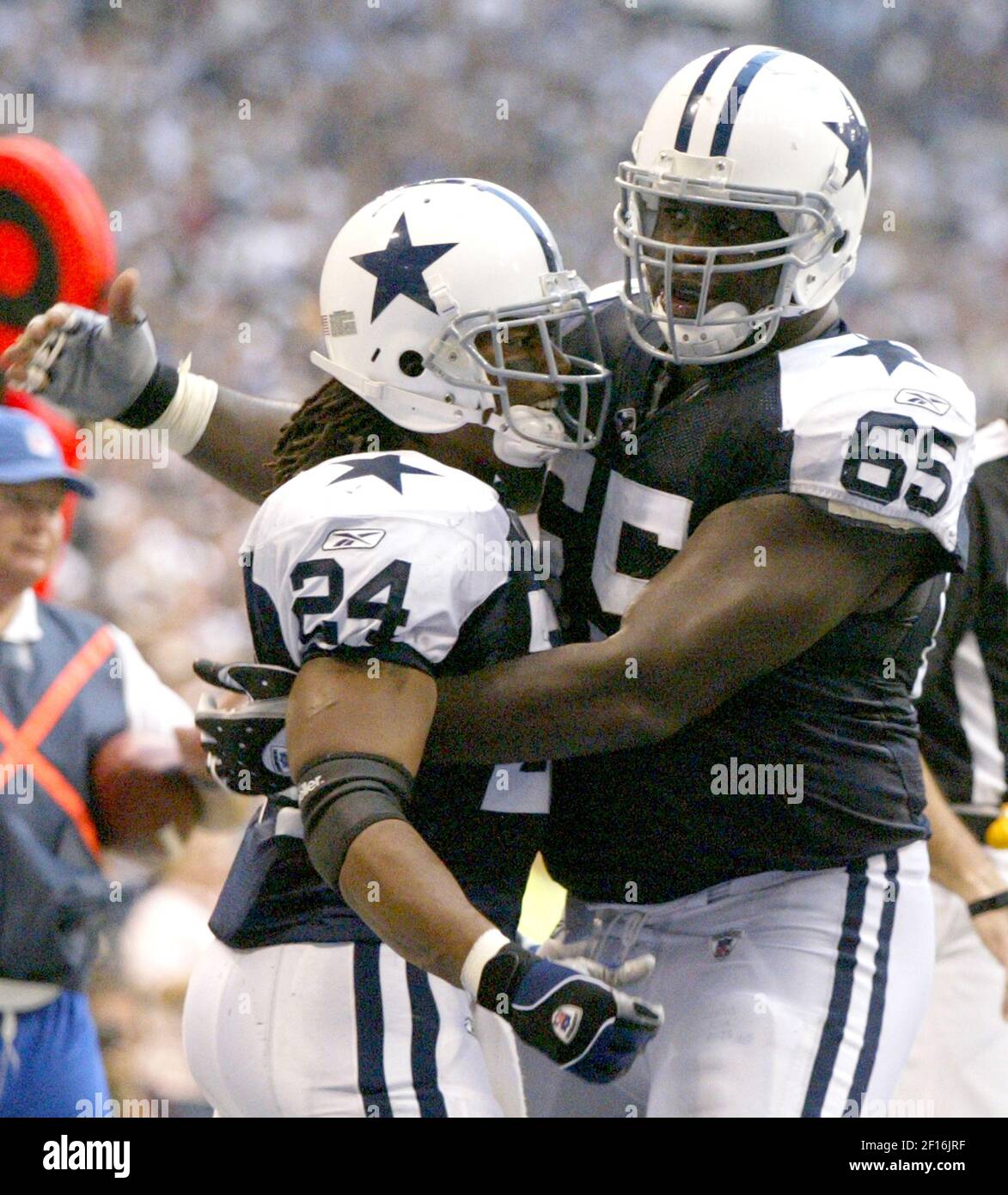 The Dallas Cowboys' Marino Barber (24) iws congratulated by Andre Gurode after scoring a touchdown in the third quarter against the Tampa Bay Buccaneers on Thursday, November 23, 2006, in Irving, Texas. (Photo by Khampha Bouaphanh/Fort Worth Star-Telegram/MCT/Sipa USA) Stock Photo