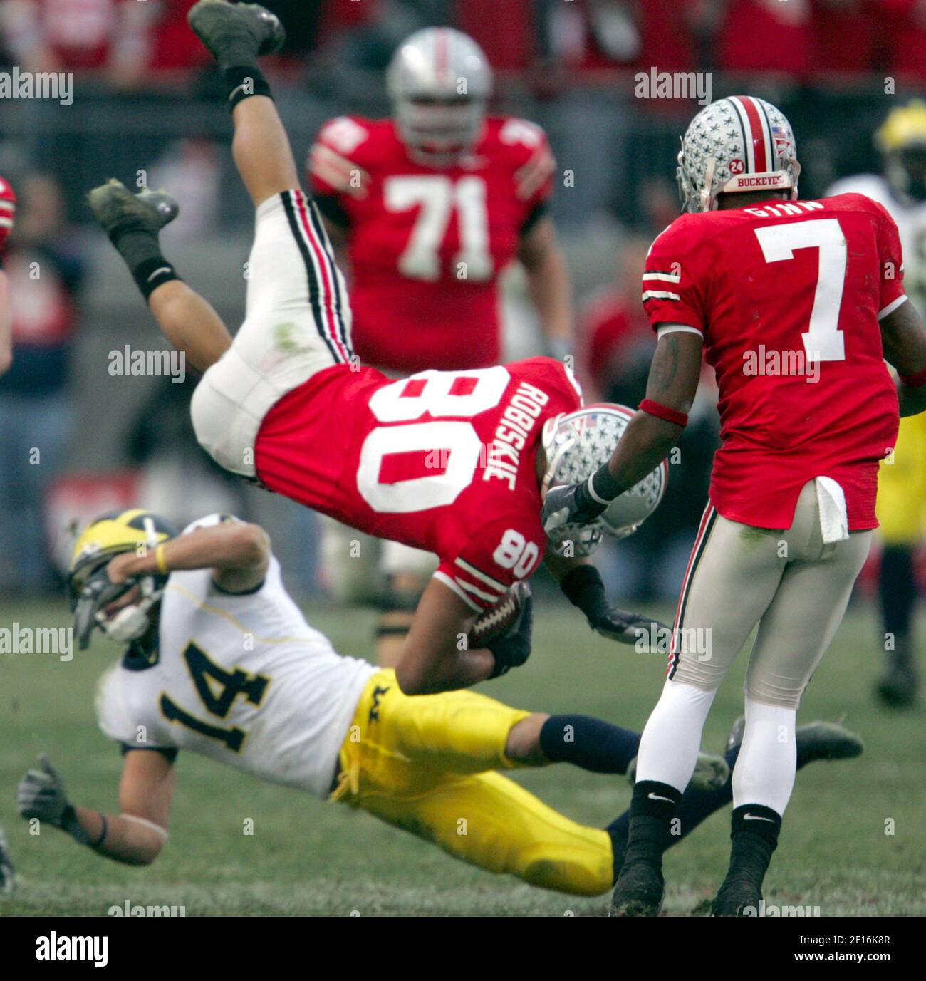Michigan's Tyrone Jordan upends Ohio State's Brian Robiskie in the ...