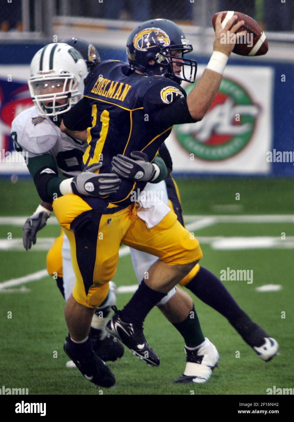 Ken State quarterback Julian Edelman (11) gets wrapped up by Ohio ...