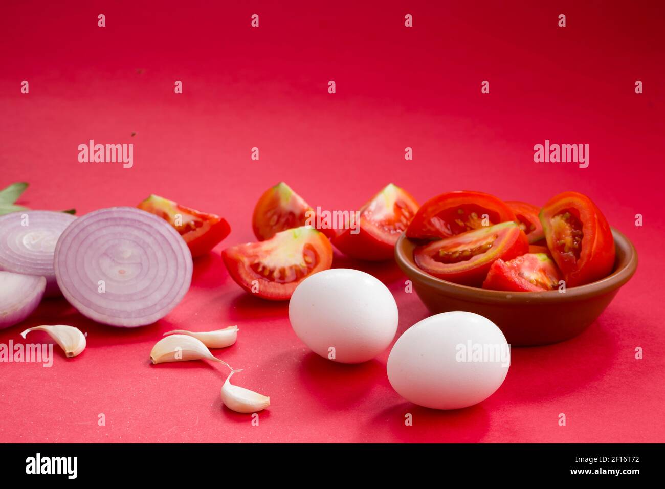 Egg masala raw cooking ingrediants,onion ,tomato,curry leaves,garlic