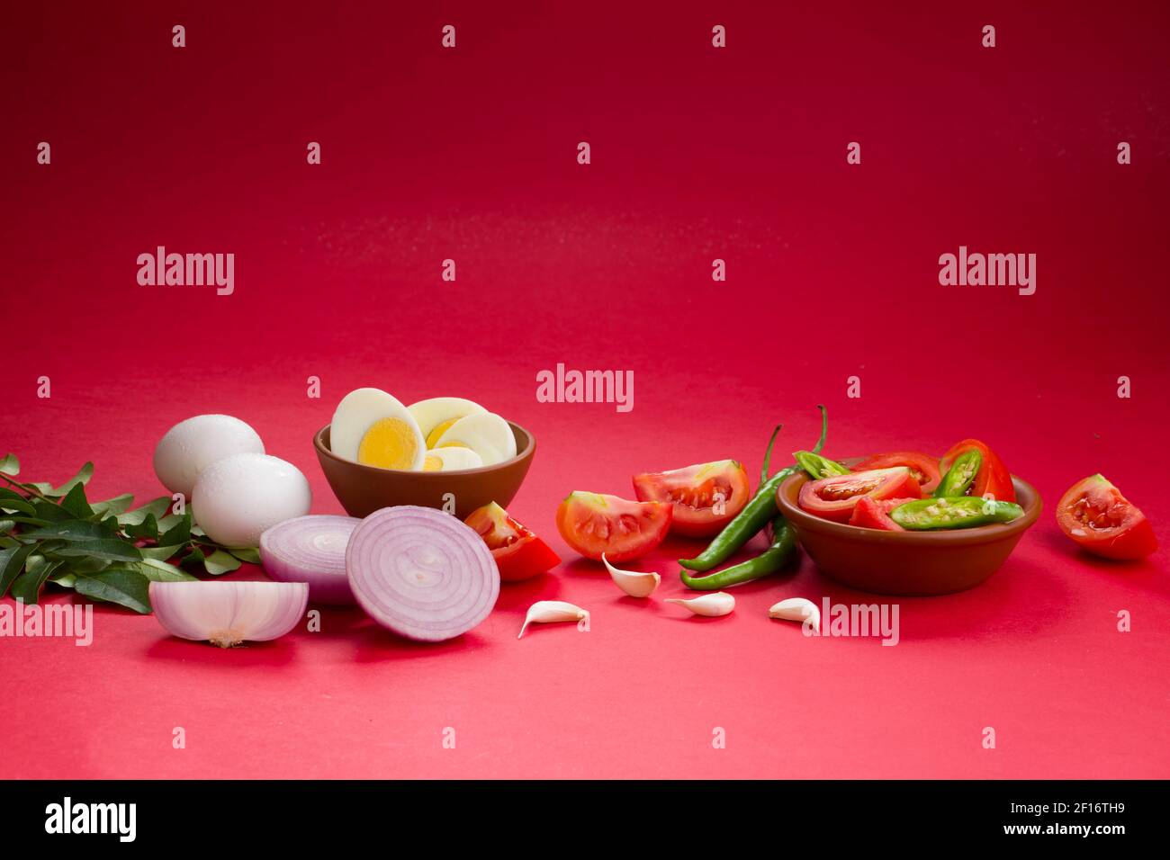 Egg masala raw cooking ingrediants,onion ,tomato,curry leaves,garlic