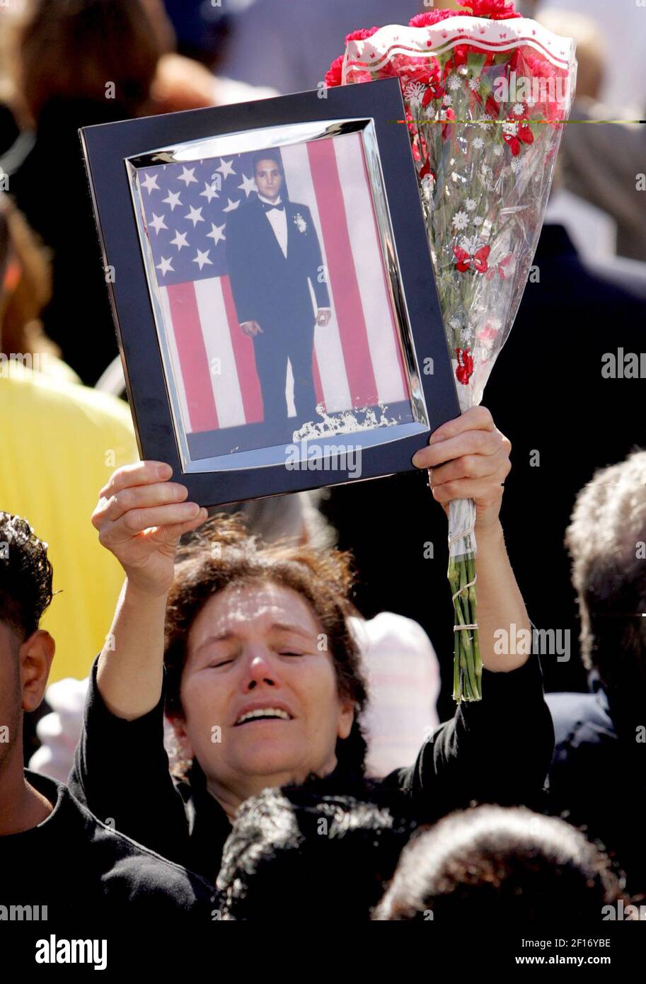 Families hold pictures of lost loved ones during the September 11th