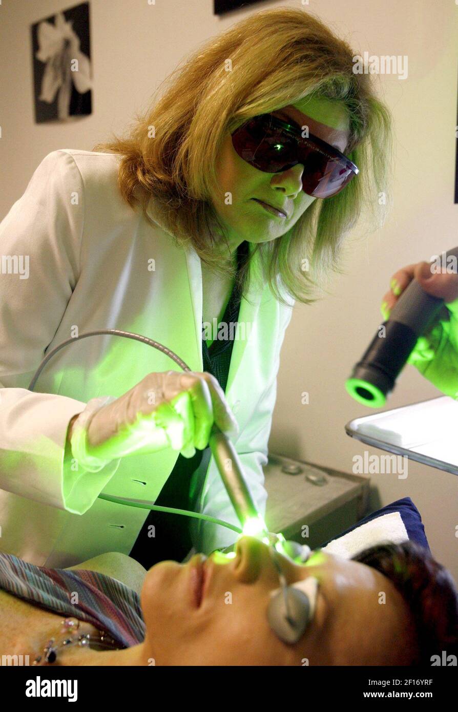Dr. Sheila Calderon (left) applies a laser to patient Valerie