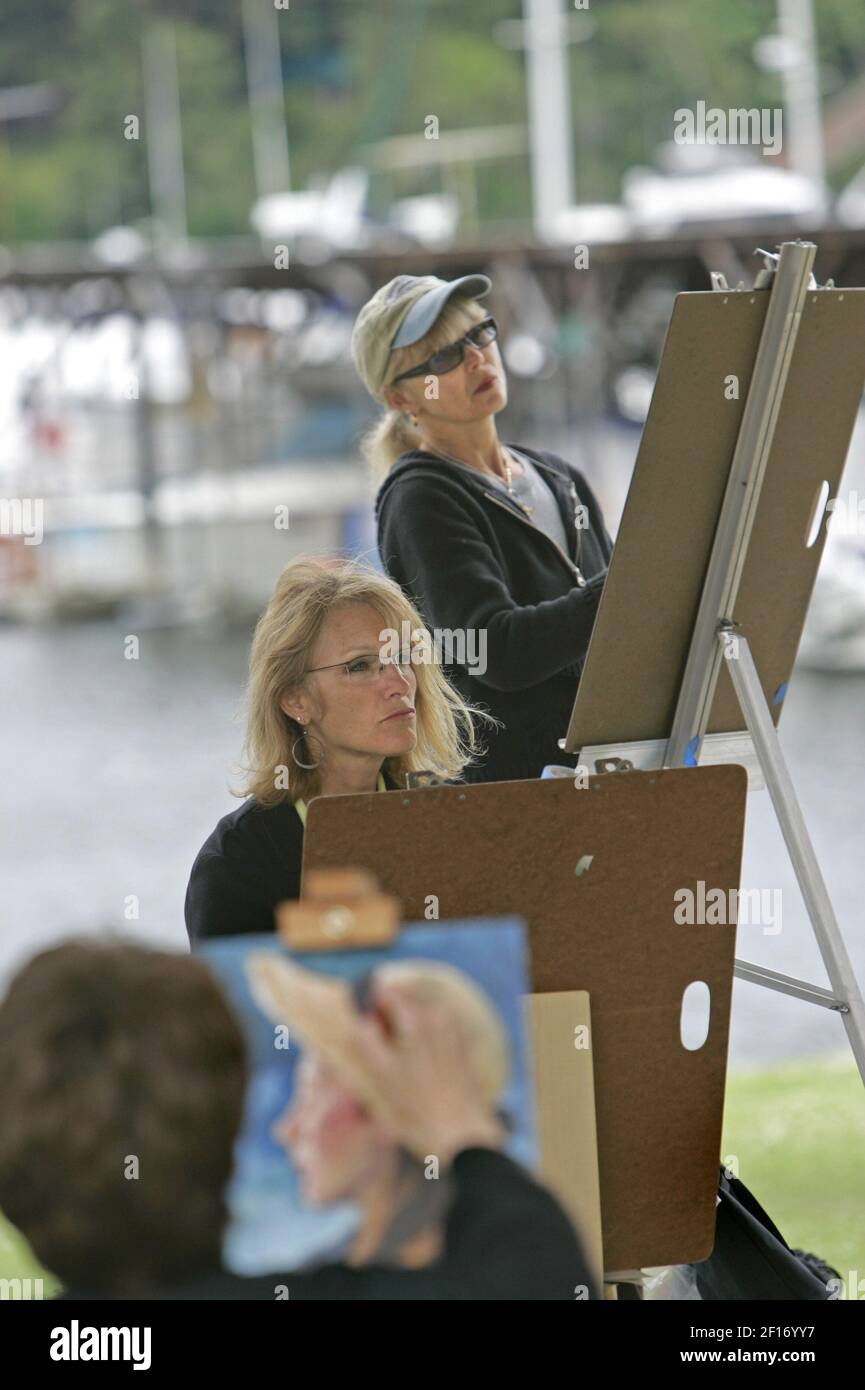 Lita Dawn Stanton, center, and Sheila Anderson, top, work on their art