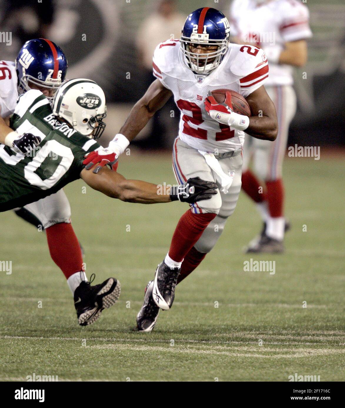 New York Giants' Tiki Barber breaks a tackle attempt by New York Jets' Eric  Barton in the first quarter during NFL football action at Giants Stadium in  East Rutherford, New Jersey, Friday,
