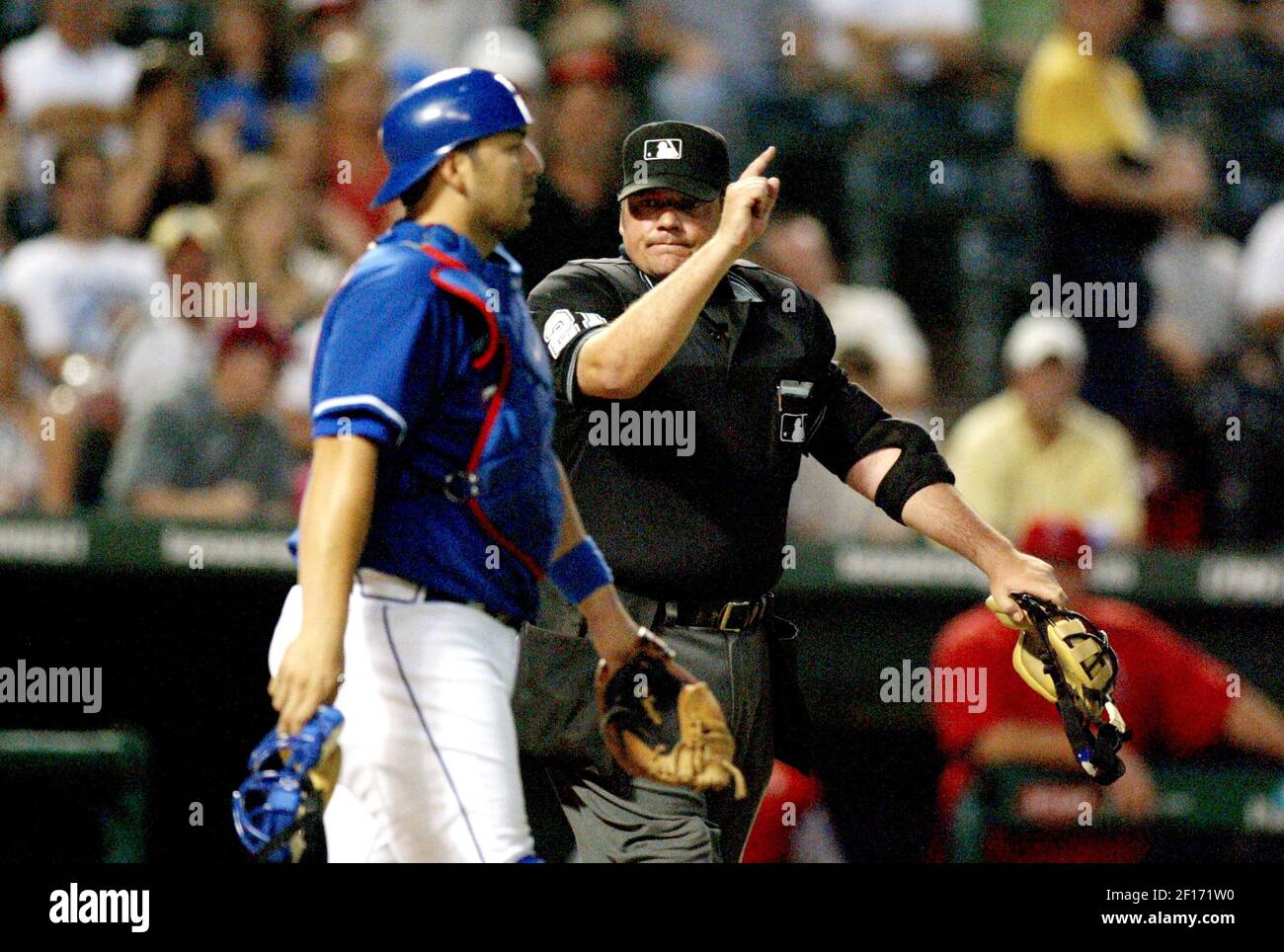 Home Plate Umpire Hunter Wendelstedt Right Gestures Ejection To Texas Rangers Catcher Rod Barajas For Pitcher Vicente Padilla S Wild Pitch That Hit Los Angeles Angles Juan Rivera In The Fourth Inning At