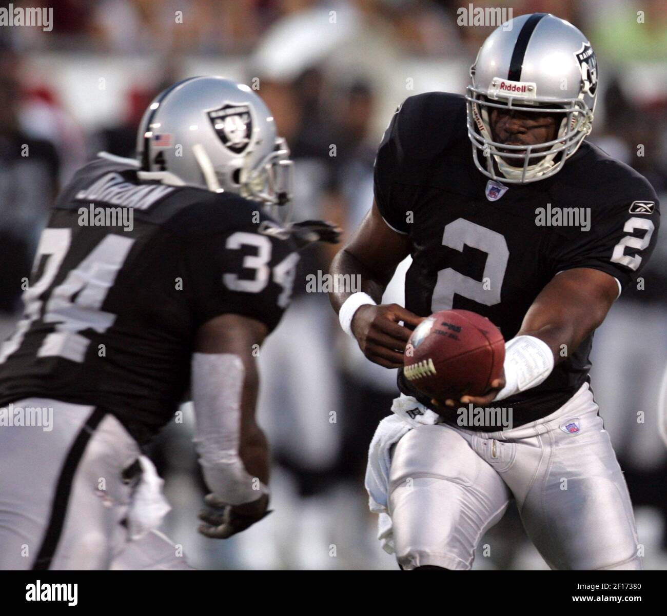 Oakland Raiders running back LaMont Jordan (34) gets the handoff from  quarterback Aaron Brooks (2) in the first quarter against the Philadelphia  Eagles in the AFC-NFC Hall of Fame Game at Fawcett