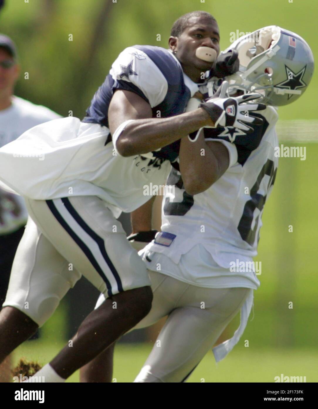 Trence Rector Dallas Cowboys' Terence Newman, left, loses his helmet after putting a ...