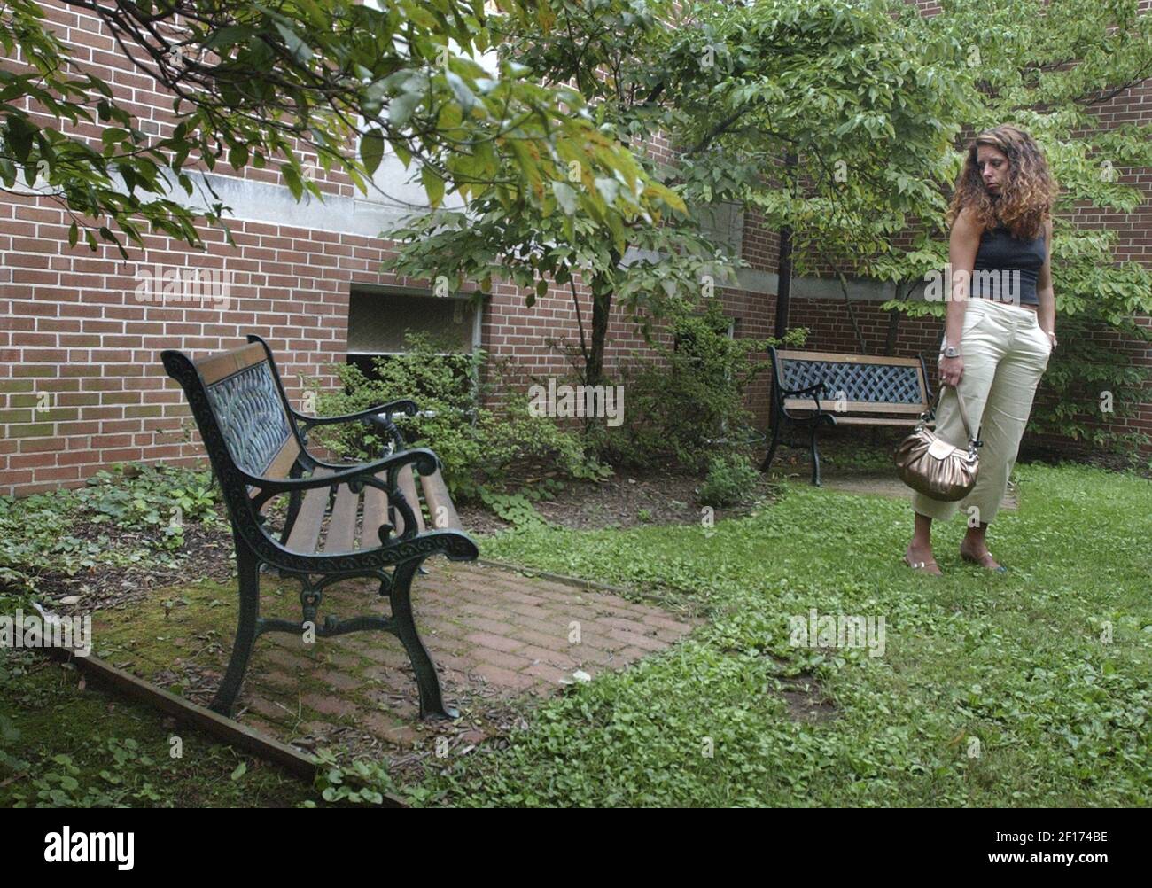 Lara Lennon looks in 2005 at a memorial bench for her husband set by a