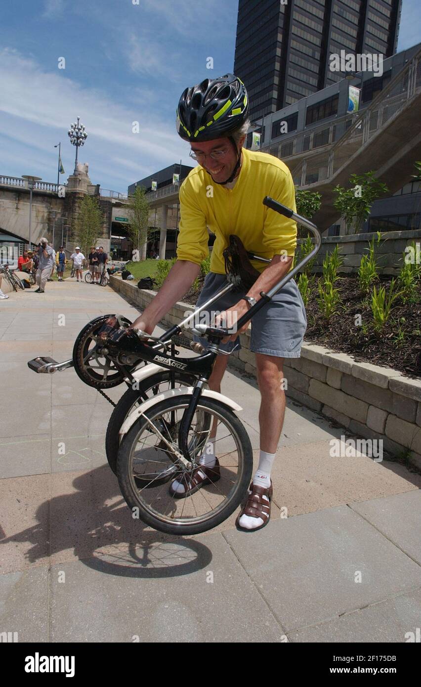 Pieter Maris works folding up his bicycle as he participates in the ...