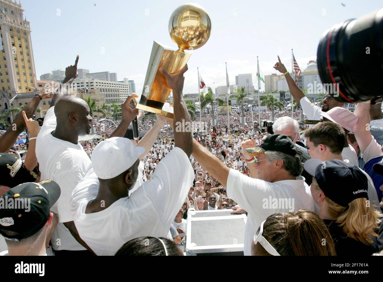 The Miami Heat s Shaquille O Neal talks to the crowd as Dwyane Wade holds the NBA trophy next to owner Micky Arison during celebrations for the Miami Heat s NBA Championship win on Friday
