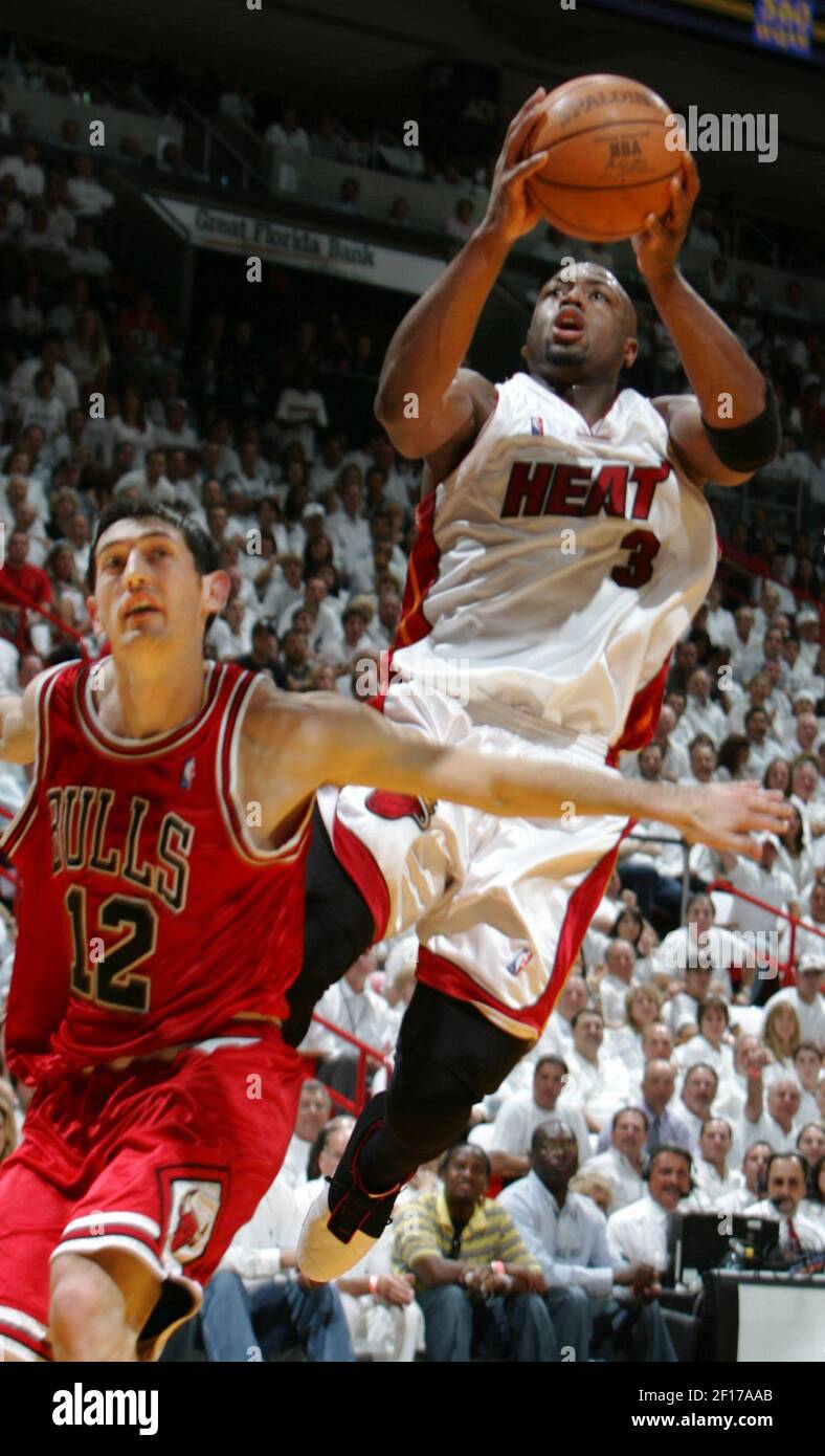 Miami Heat guard Dwyane Wade (3) scores over the Chicago Bulls' Kirk ...