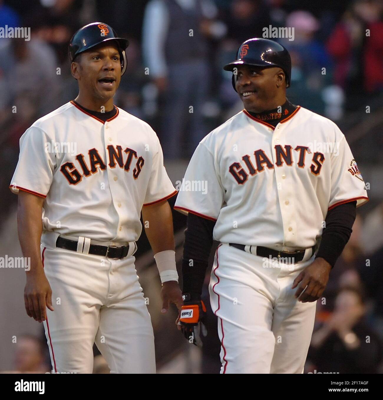 San Francisco Giants Moises Alou (left) walks back to the dugout with  teammate Barry Bonds, after hitting a 3-run home run against New York Mets  in the first inning at AT&T Park