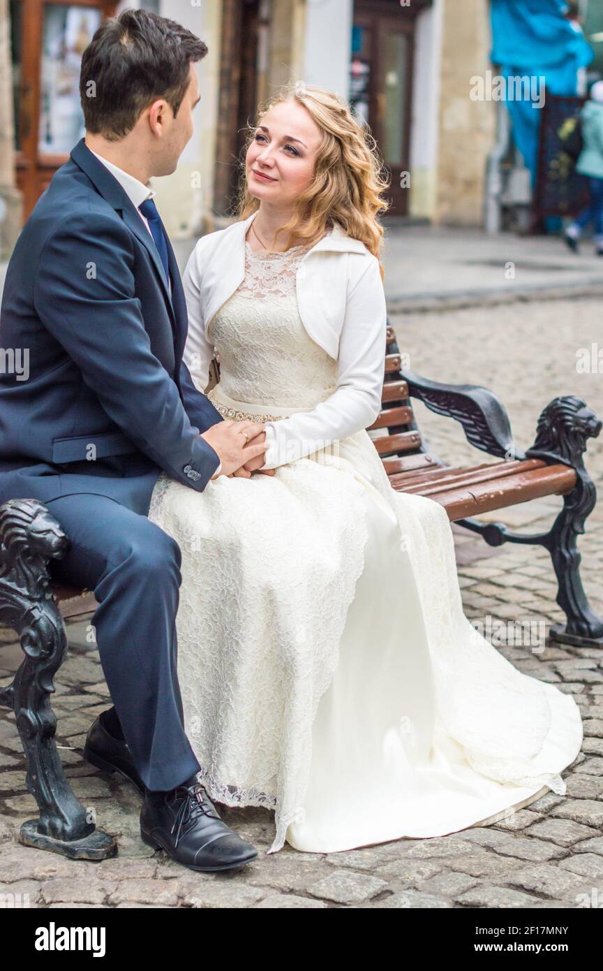 Newlyweds sit on the bench Stock Photo Alamy