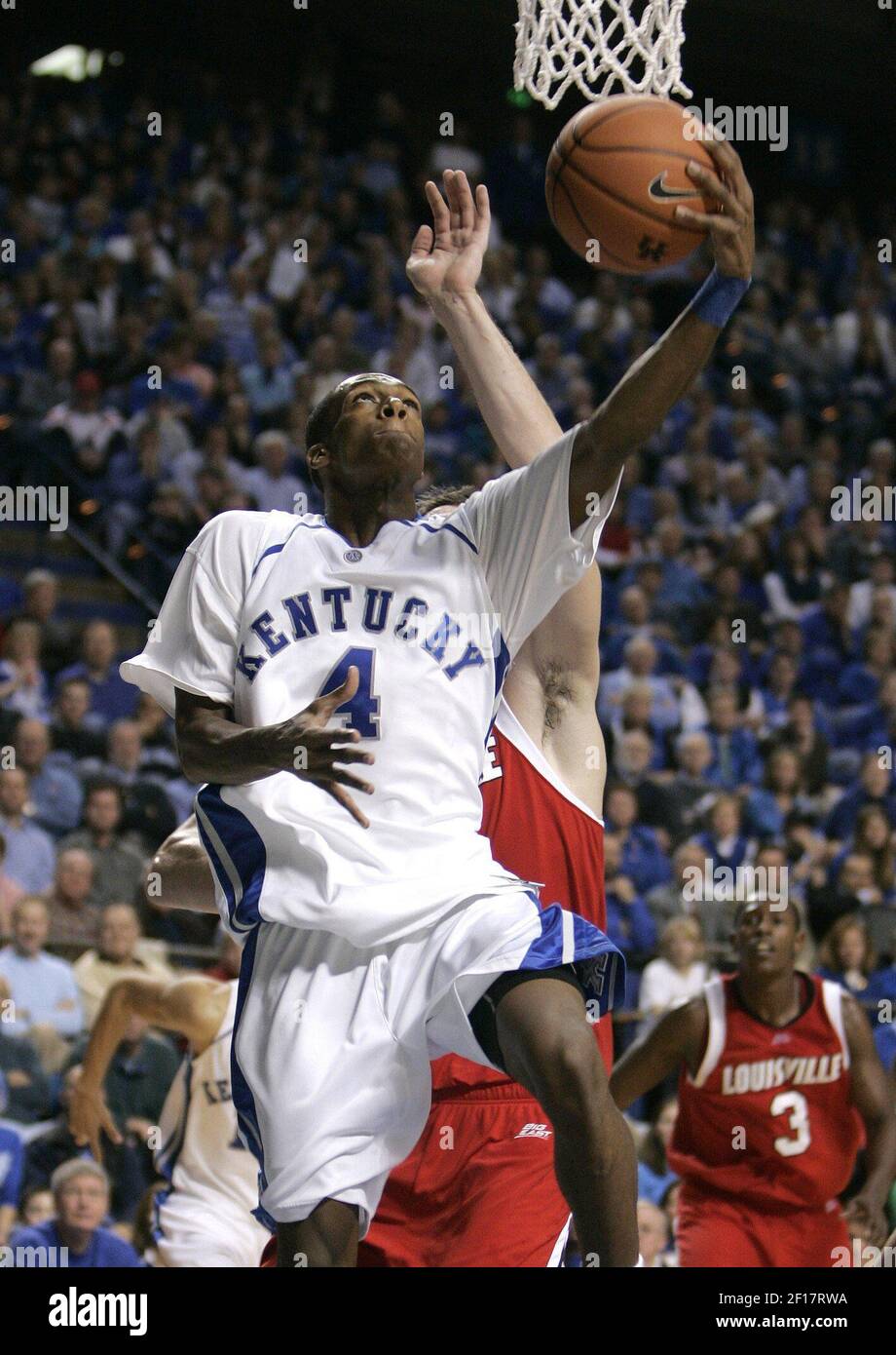 Kentucky's Rajon Rondo goes up for a layup under Louisville's David ...