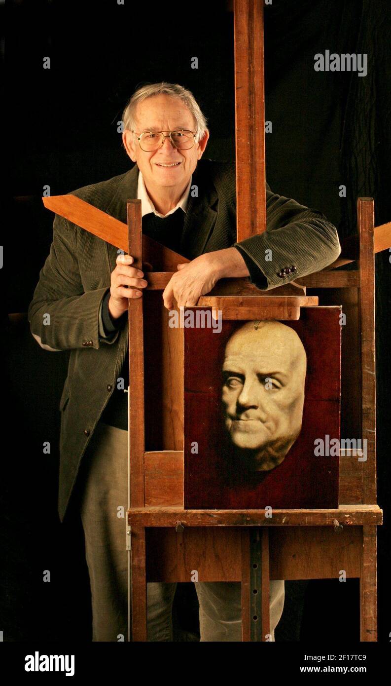 Timothy Jayne, art restorer, poses with a death mask painting of