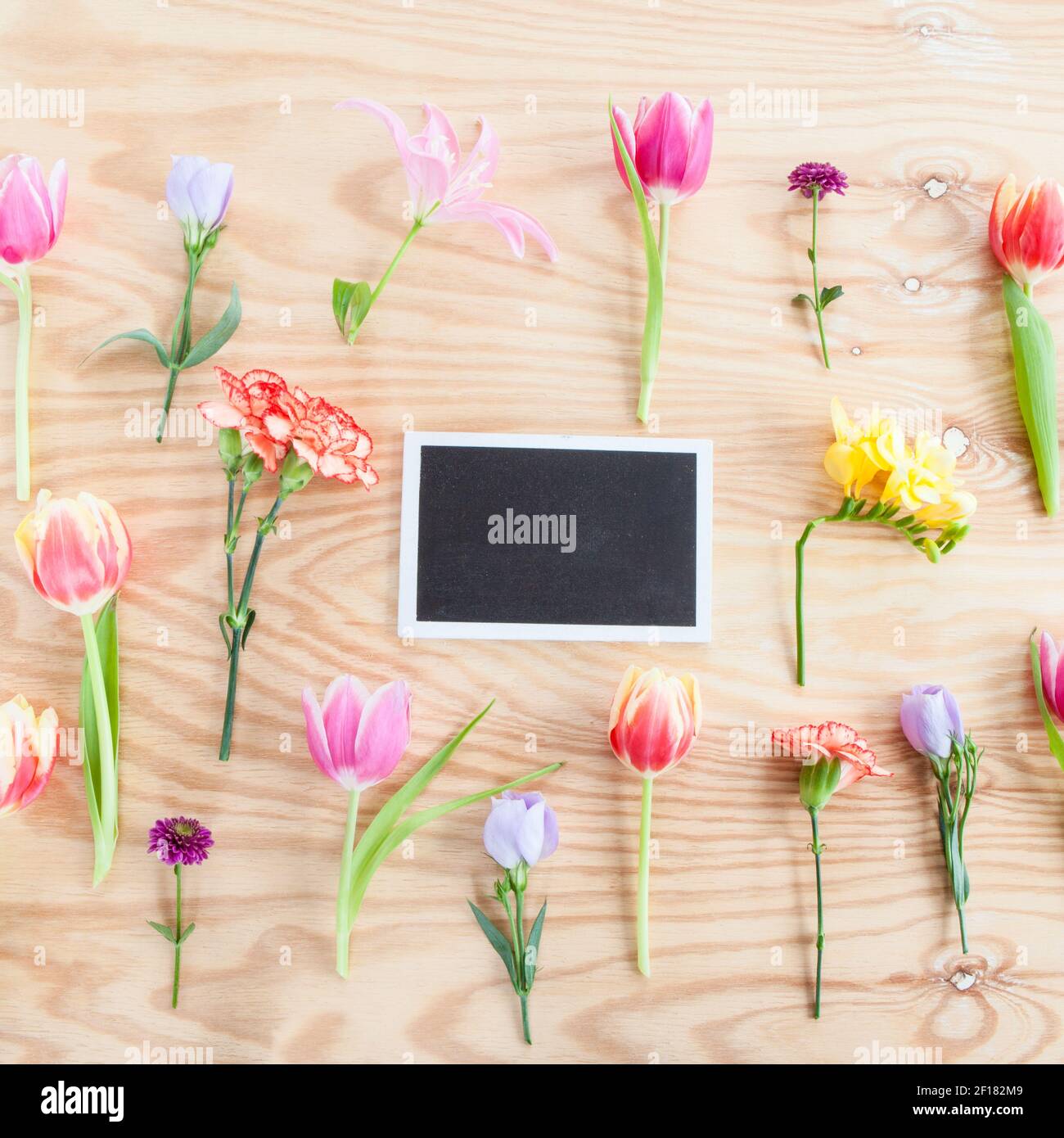 Mixed flowers on wooden background Stock Photo