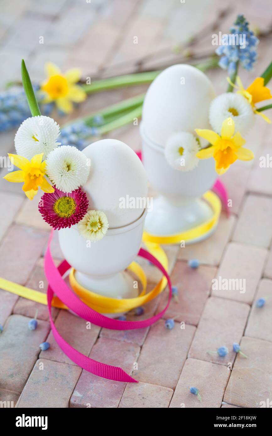 Eggs in egg cups with small flowers Stock Photo
